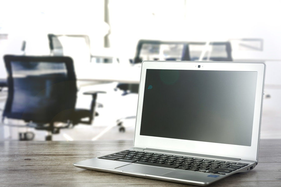 laptop on table in office